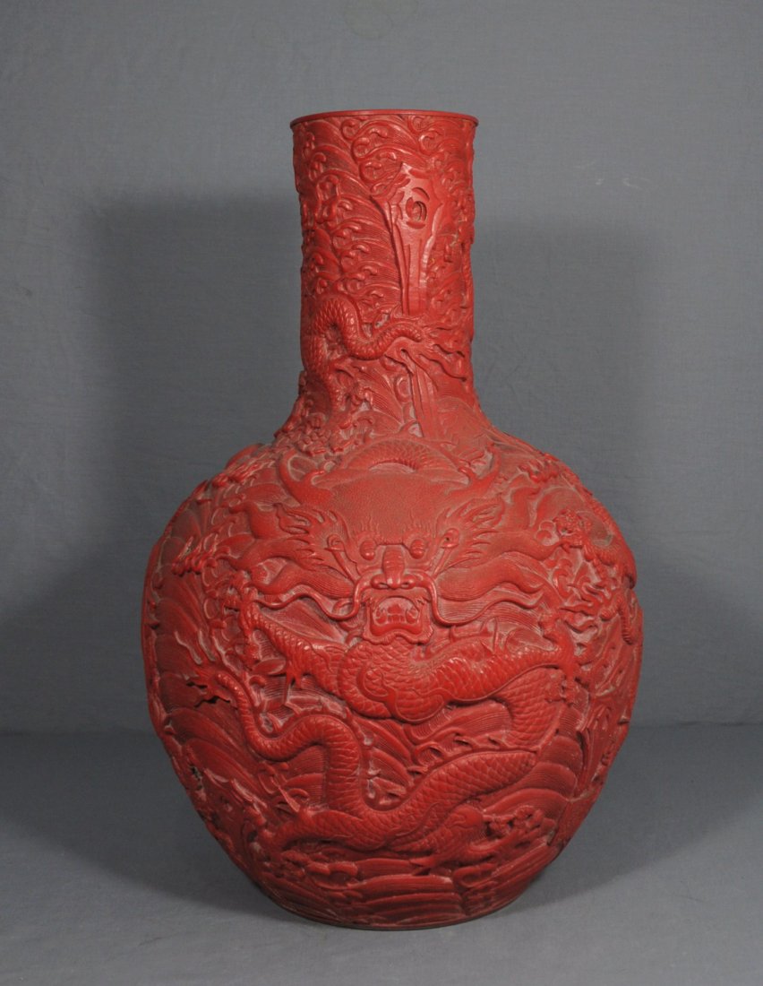 Chinese Red Glaze High Relief Porcelain Bal: Chinese red glaze high relief porcelain ball vase, decorated with dragons. Qian-Long mark and period. Minor chip on the base, Overall good condition. 21.5" height.