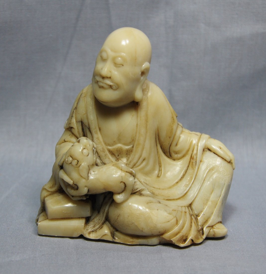 Nice Carved Chinese Shou-Shan Stone Louhan Figure: Nice carved Chinese shou-shan stone louhan figure, decorated with seated louhan holding a dog. 4" height x 3.75" wide.