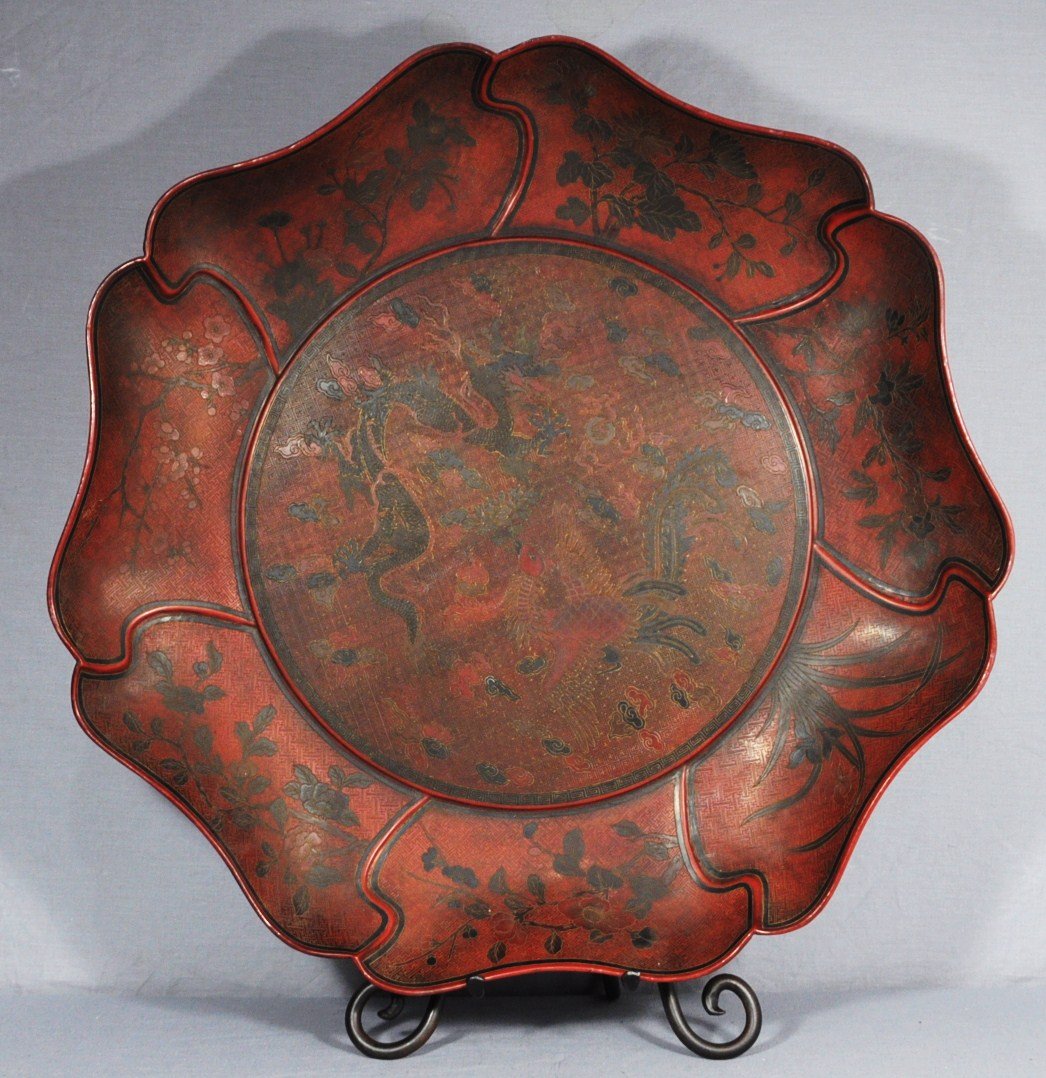 Large Chinese Lacquer Charger With Mark: Large Chinese lacquer charger with mark, decorated with dragon and phoenix around by flowers. Early 20th century. Good condition. 23" diam.