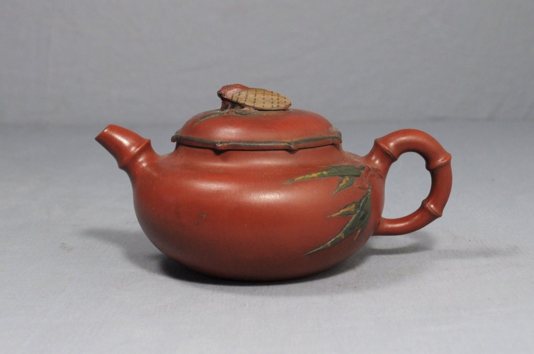 Chinese Ceramic Teapot with mark: Chinese ceramic teapot with mark, decorated with bamboo leaf and cicada. Early 20th century. 6.75" wide x 3.5" height.