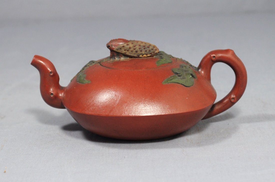 Chinese Ceramic Teapot with mark: Chinese ceramic teapot with mark, decorated with cicada on the top of the cover. Early 20th century. 6" wide x 2.5" height.