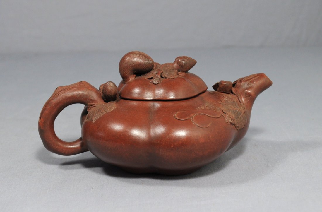 Chinese Ceramic Teapot with mark: Chinese ceramic teapot with mark, decorated with squirrel and leafs . 7.5" wide x 3.5" height.