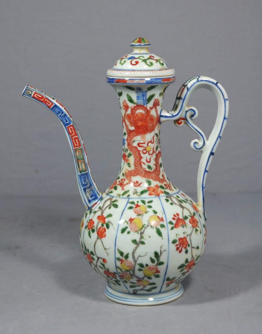 Chinese Wu-Cai Porcelain Teapot: Chinese wu-cai porcelain teapot with handle, decorated with different color dragons and peach tree . 19th century. Good condition. 10.5" height.