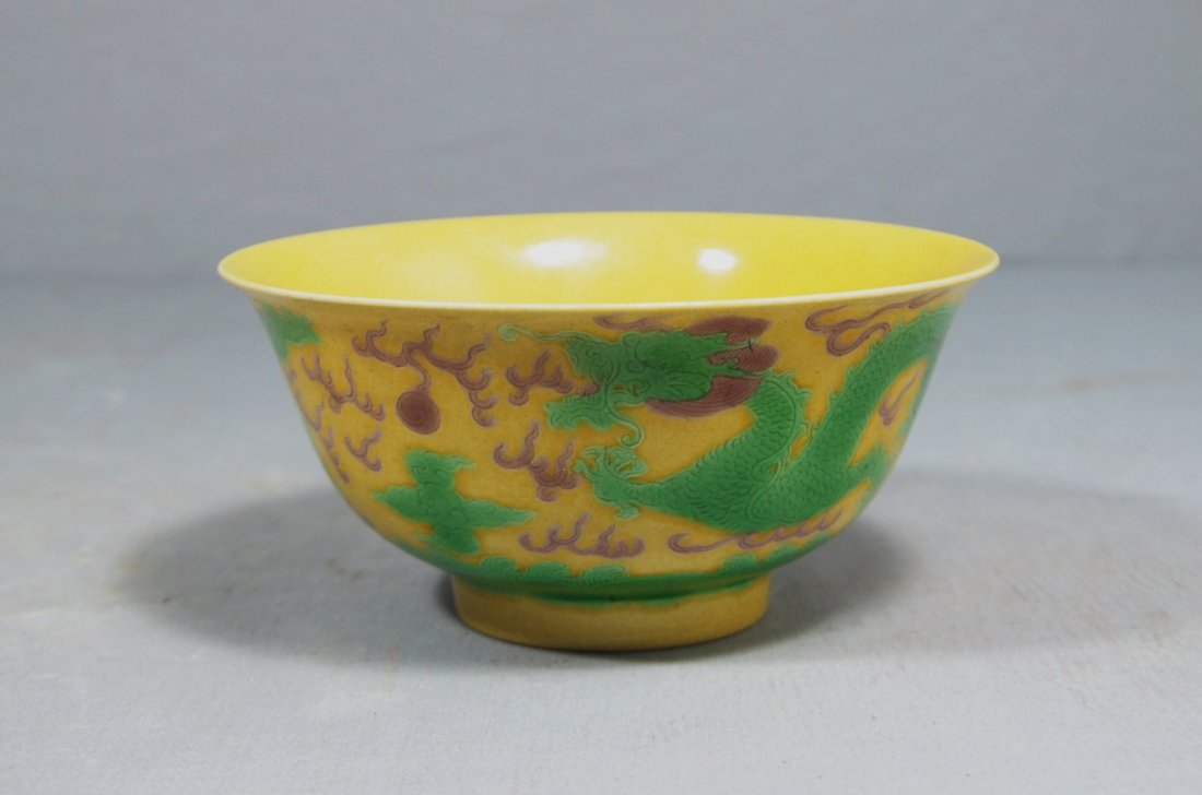 3090: Chinese Yellow Glaze Porcelain Bowl: Chinese yellow glaze porcelain bowl, decorated with dragons. Six black character under glaze mark on the base. Good condition. 6" diam x 2.5" height.