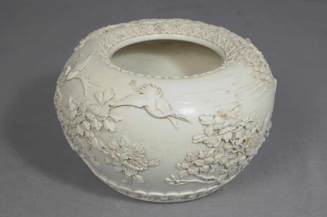 Chinese High Relief White Glaze Porcelain B: Chinese high relief white glaze porcelain brush washer, decorated with pine trees and birds. Six relief character mark on the base. Good condition. 7.75" diam x 4.75" height.