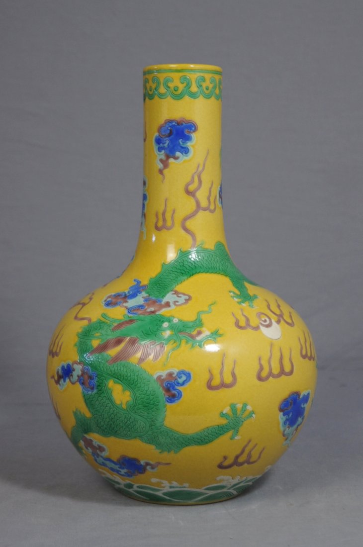 Chinese Yellow Base Famille Rose Porcelain: Chinese yellow base with famiile rose porcelain bottle vase, decorated with dragon and fire. Six black character under glaze mark on the base. Good condition. 11.25" height.