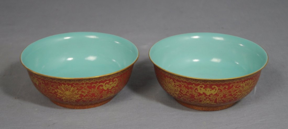 Pair of Chinese Red Glaze Porcelain Bowls: Pair of Chinese red glaze porcelain bowls, decorated with gilt bats and floral. Six red character under glaze mark on the base. Good condition. 4.9" diam x 1.9" height.