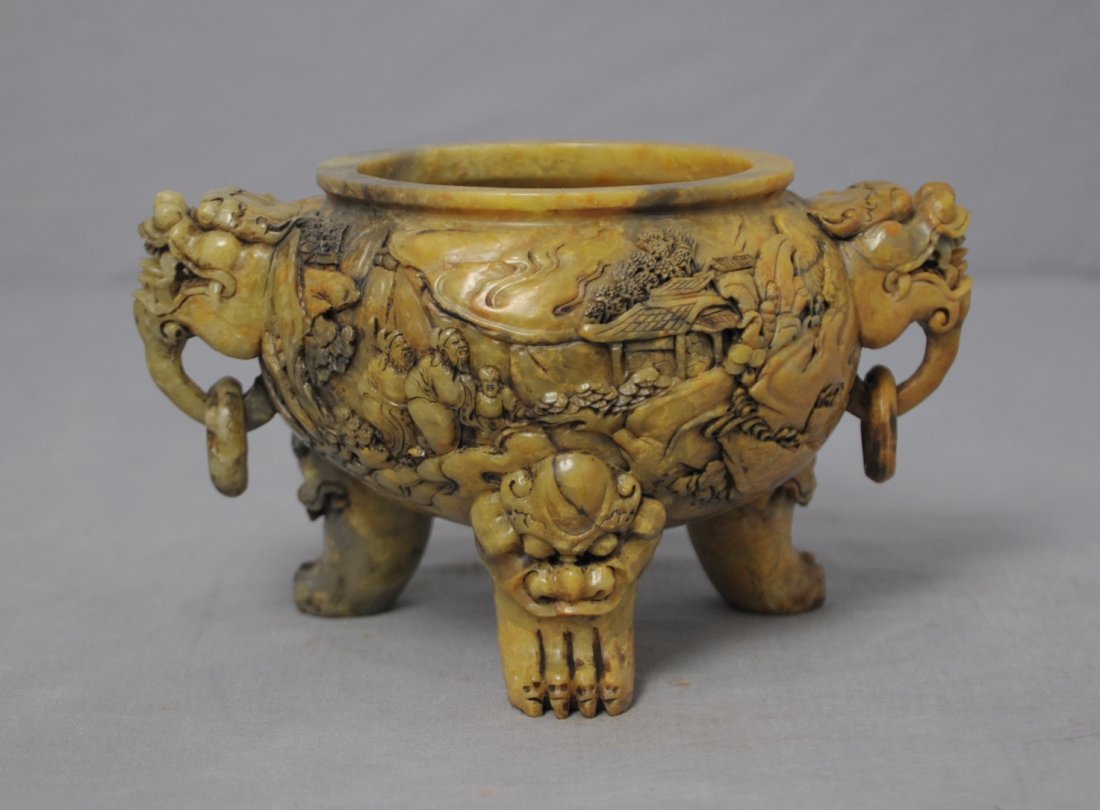 Well Hand Carved Chinese Shou-Shan Stone Ce: Well hand carved Chinese shou-shan stone tripod censer, decorated with lion heads for the handle and legs,also landscape view and figures. Early 20th century. 6.5" wide and 4" height.