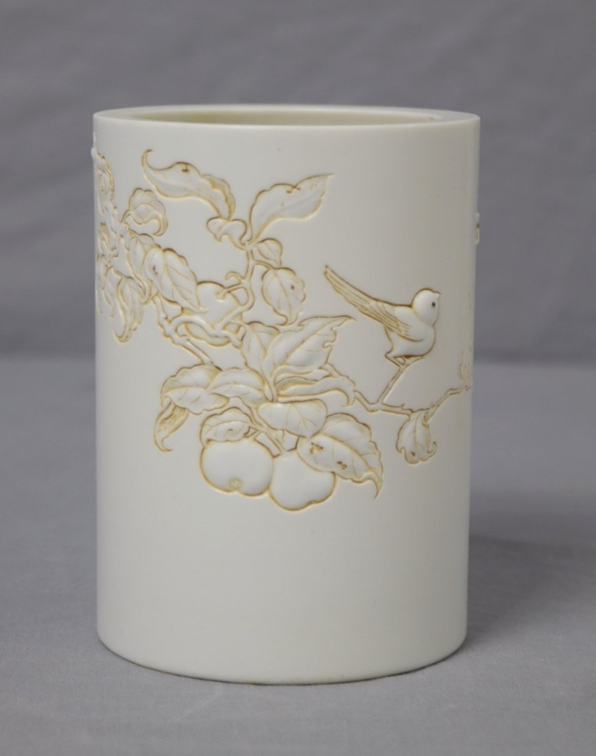 Chinese Relief White Biscuit Porcelain Pen H: Chinese relief white biscuit porcelain pen holder, decorated with bid and tree branch. Studio mark on the base. 4" height x 3" wide.