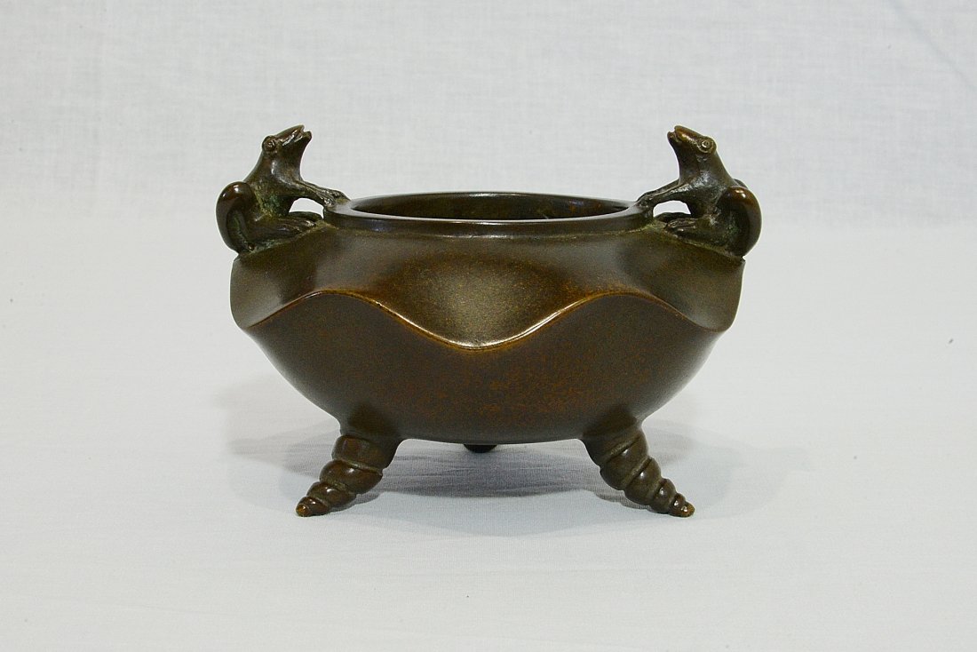 Chinese Bronze Tripod Incense Burner With Mark: Chinese bronze tripod incense burner, decorated with two frogs on the top. Four relief character mark on the base. Good condition. 5" diam x 2.75" height.