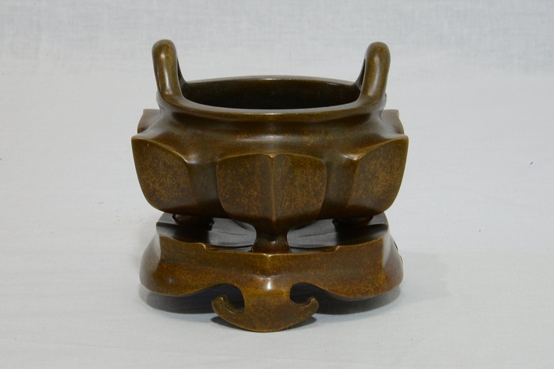Chinese Bronze Tripod Censer On Stand With Mark: Chinese bronze tripod incense burner on the bronze stand. Four relief characterstudio mark on the bottom. Good condition. 4.5" diam x 3.75" height.