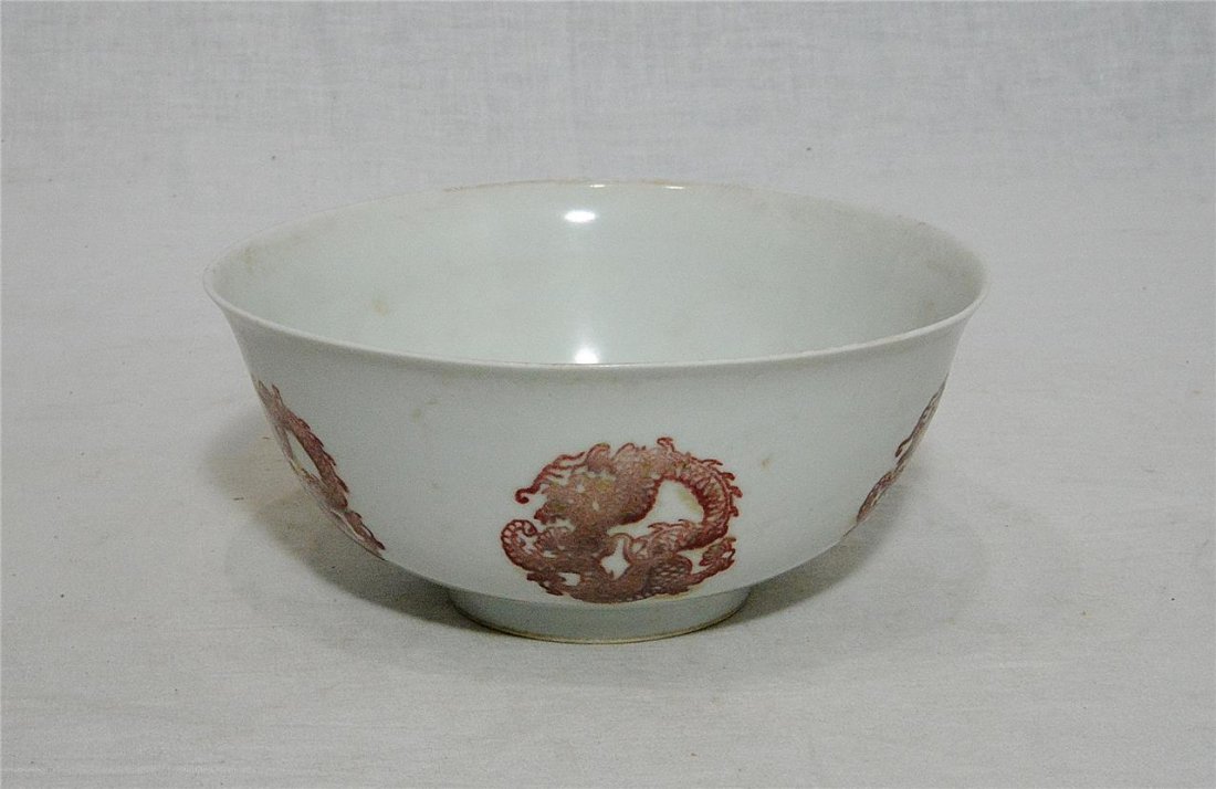 Chinese Red and Whte Poecwlain Bowl With Mark: Chinese red and white porcelain bowl, decorated with dragons. Six blue Chinese character under glaze mark on the base. Good condition. 6" wide x 2.6" height.