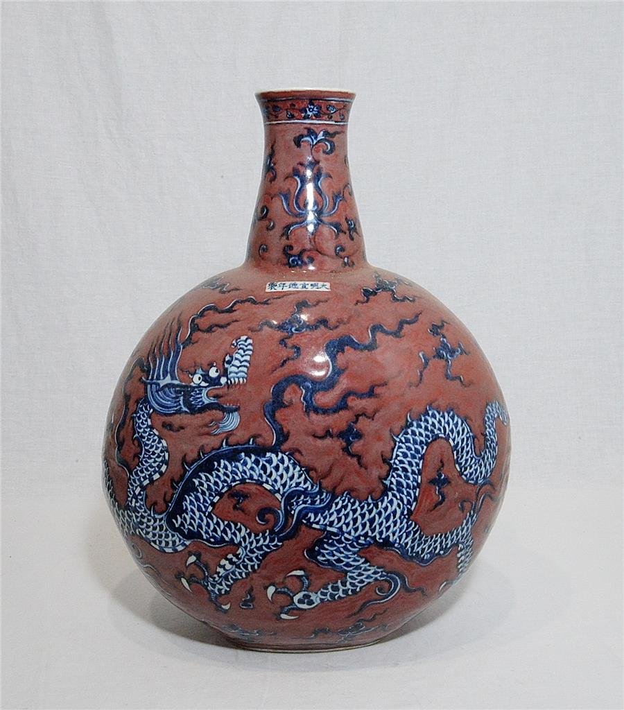 Chinese Iron Red Porcelain Vase With Mark: Chinese iron red porcelain vase, decorated with blue and white dragons. Six blue Chinese character under glaze mark on the base. Good condition. 18.5" height.
