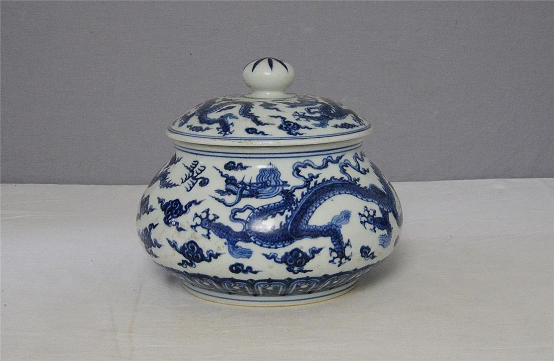 Chinese Blue and White Porcelain Jar With Mark: Chinese blue and white porcelain jar, decorated with dragons and clouds. Six blue Chinese character under glaze mark on the base. Good condition. 8.5" wide x 7" height.