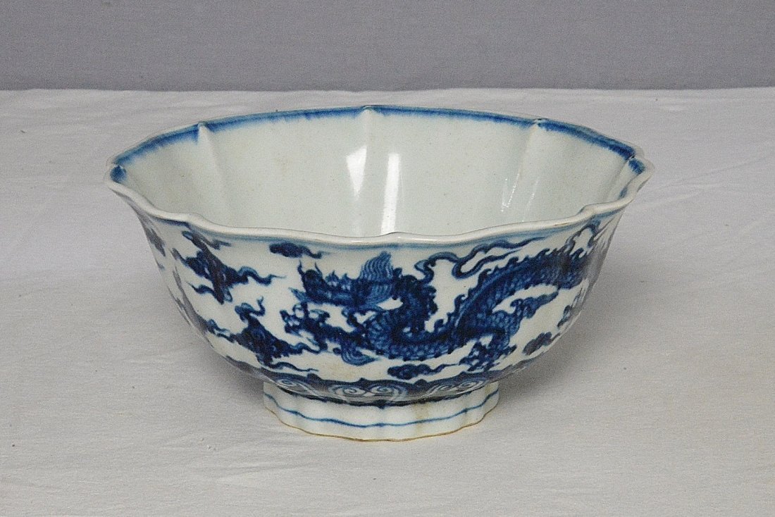 Chinese Blue and White Porcelain Bowl With Mark: Chinese blue and white porcelain bowl, decorated with dragons and flowers. Six blue Chinese character under glaze mark. Good condition. 7" diam x 3.25" height.