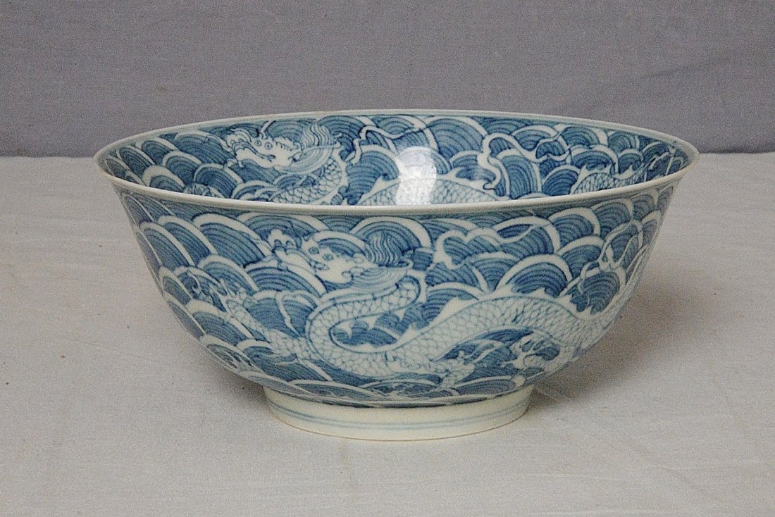 Chinese Blue and White Porcelain Bowl With Mark: Chinese blue and white porcelain bowl, decorated with dragons and waves. Six blue Chinese character under glaze mark on the base. Good condition. 7.3" diam x 3.2" height.