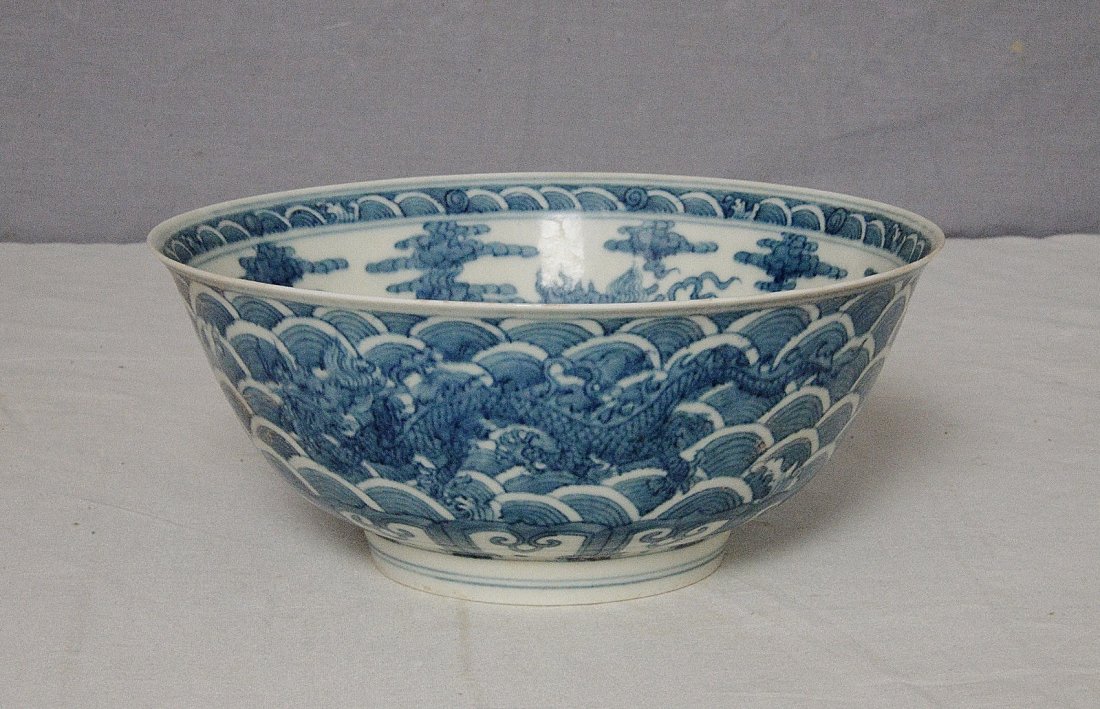 Chinese Blue and White Porcelain Bowl With Mark: Chinese blue and white porcelain bowl, decorated with dragons and waves. Six blue Chinese character under glaze mark on the base. Good condition. 7.5" diam x 3.15" height.