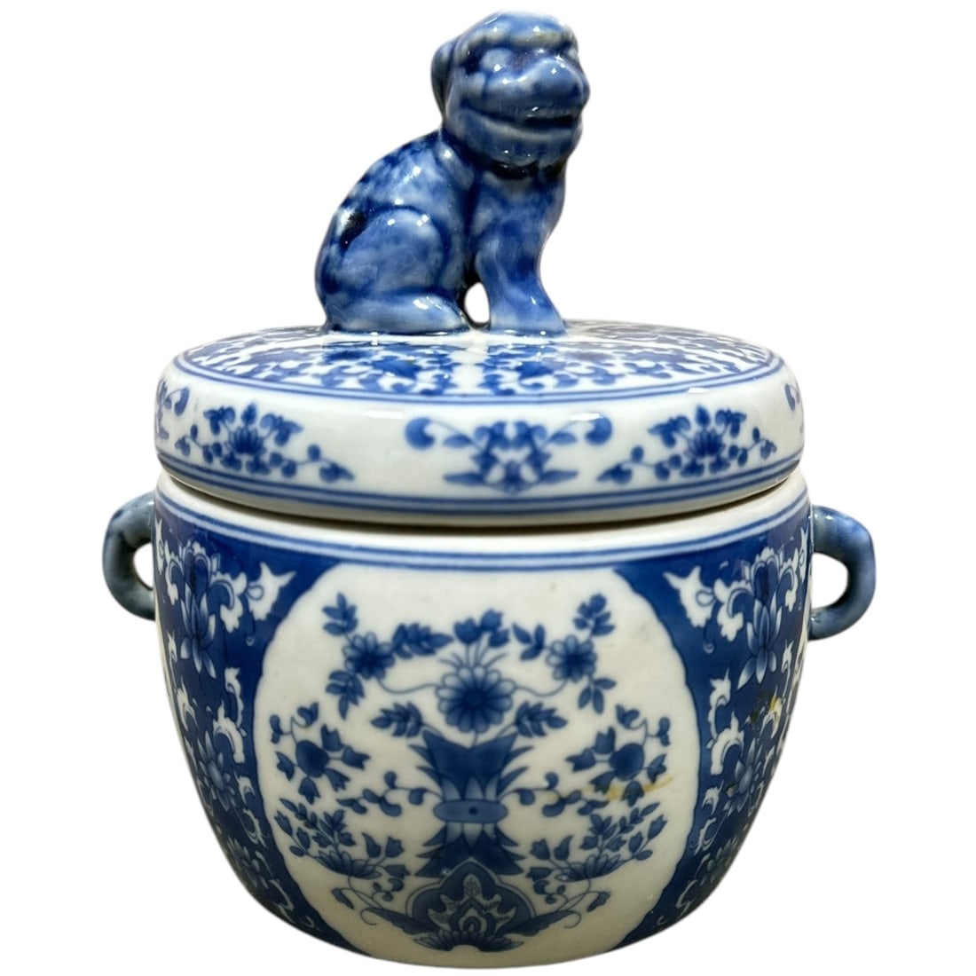 NO RESERVE- Blue and White Covered Dish with Foo Dog Finial: An exquisite blue and white porcelain jar with intricate floral motifs and symmetrical designs. The lid is topped with a finely sculpted Foo Dog (guardian lion) finial, a traditional Chinese symbol of