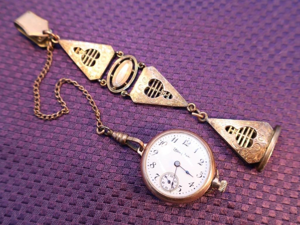 Antique Golld Gold Ladies Hampden "Molly Stark" gold filled and a matching chatelaine: The chatelaine is a decorative belt hook or clasp with a series of suspended chains and hinged panels, used in the 18th and 19th centuries to hold practical items like watches, keys, or seals. This on