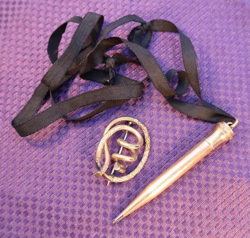 Vintage gold-filled mechanical pencil and antique Victorian gold-filled love knot brooch: The brooch is likely made of less expensive gilt metal such as rolled gold or pinchbeck, common for jewelry of that period. The pin stem is often made of a base metal to make it more durable. Click on