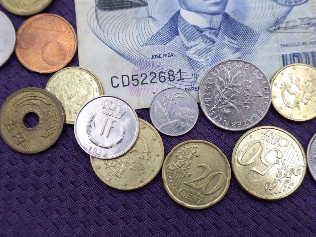 A collection of Philippine peso coins and a banknote - 2