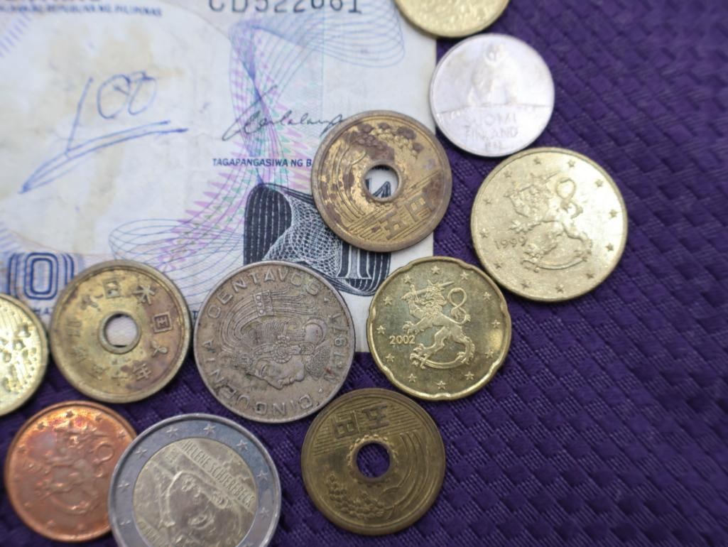 A collection of Philippine peso coins and a banknote - 4