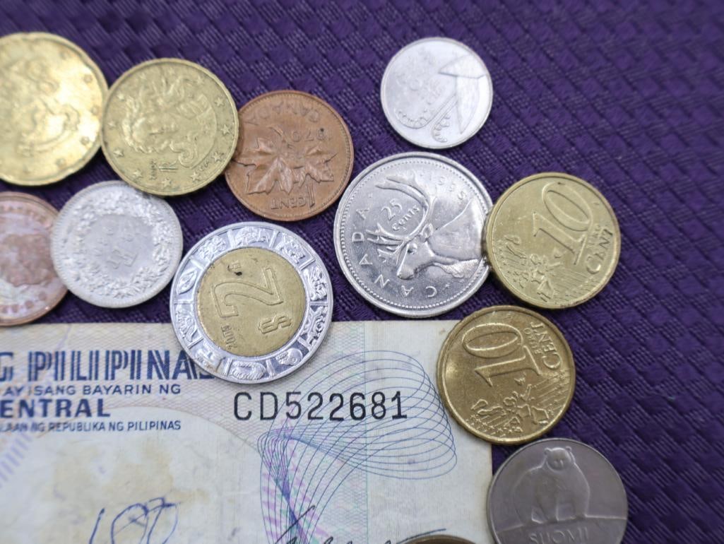 A collection of Philippine peso coins and a banknote - 5