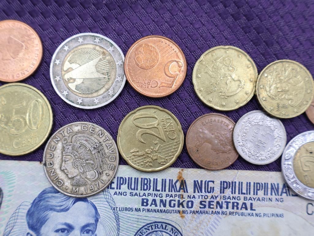 A collection of Philippine peso coins and a banknote - 6