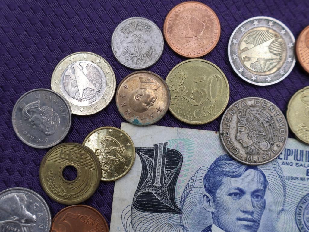 A collection of Philippine peso coins and a banknote - 7