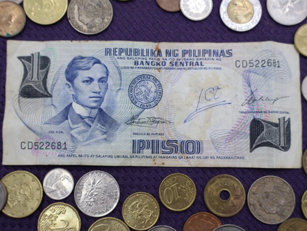 A collection of Philippine peso coins and a banknote - 8