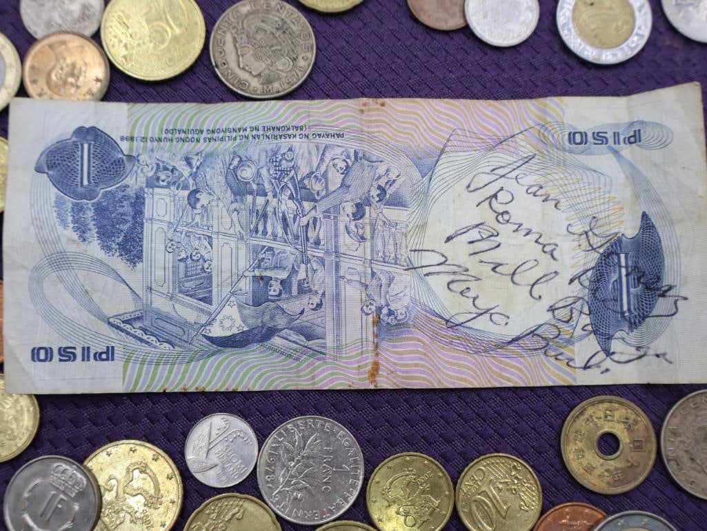 A collection of Philippine peso coins and a banknote - 9