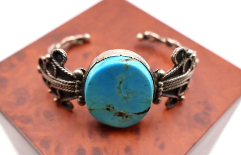Vintage sterling silver cuff bracelet with a large, oval turquoise-colored stone (1 of 7)