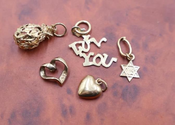 Collection of various gold jewelry charms (1 of 14)