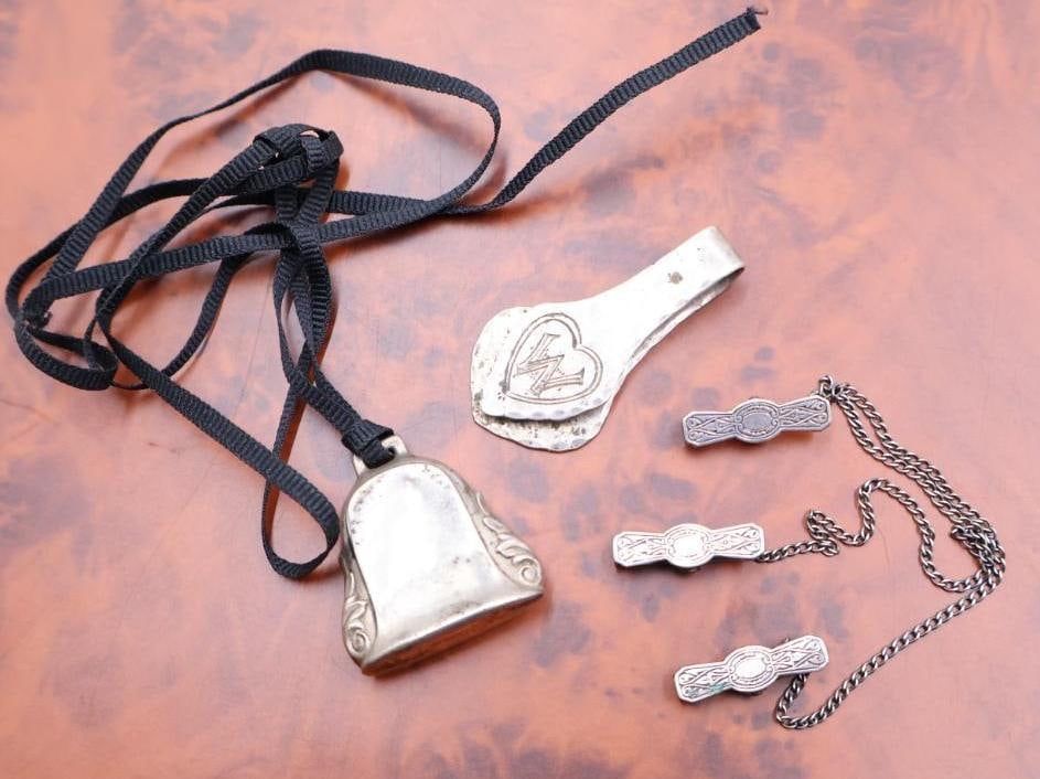 Vintage sterling silver baby rattle, antique silver money clip: Antique sterling silver napkin clip, potentially also used as a money clip, featuring a hammered finish and an engraved initial 'W' inside a heart motif, sterling rattle on black ribbon, and a long