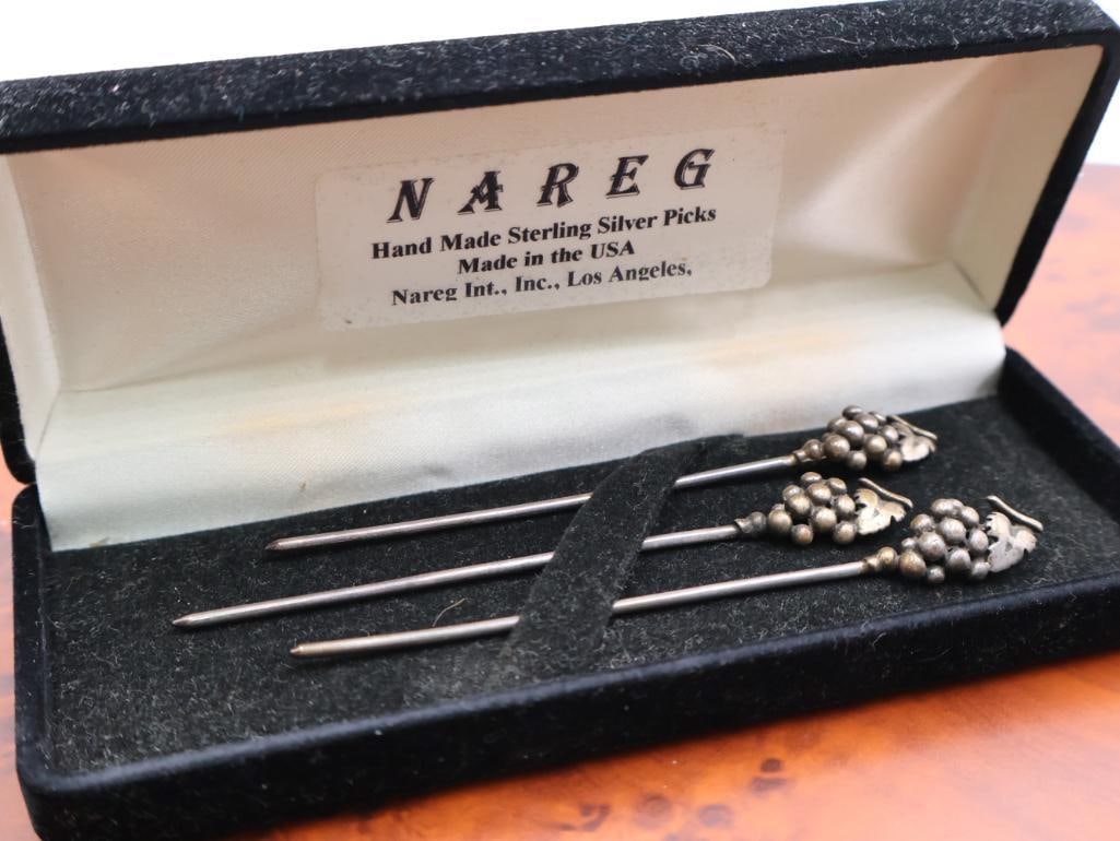 Set of Nareg handmade sterling silver cocktail or hors d'oeuvre picks: They are made of sterling silver. The picks feature a grape cluster design at the top. 