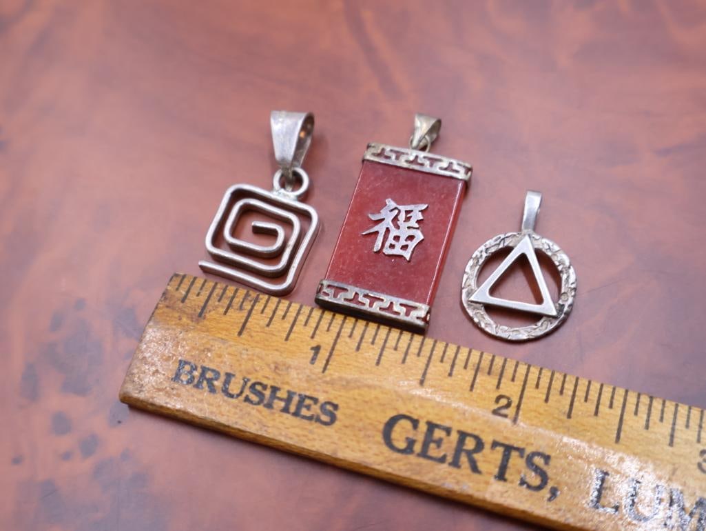 A red jade pendant and two sterling pendants - 2