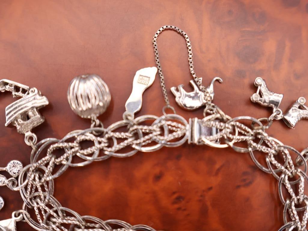 Vintage sterling silver charm bracelet with various charms - 6