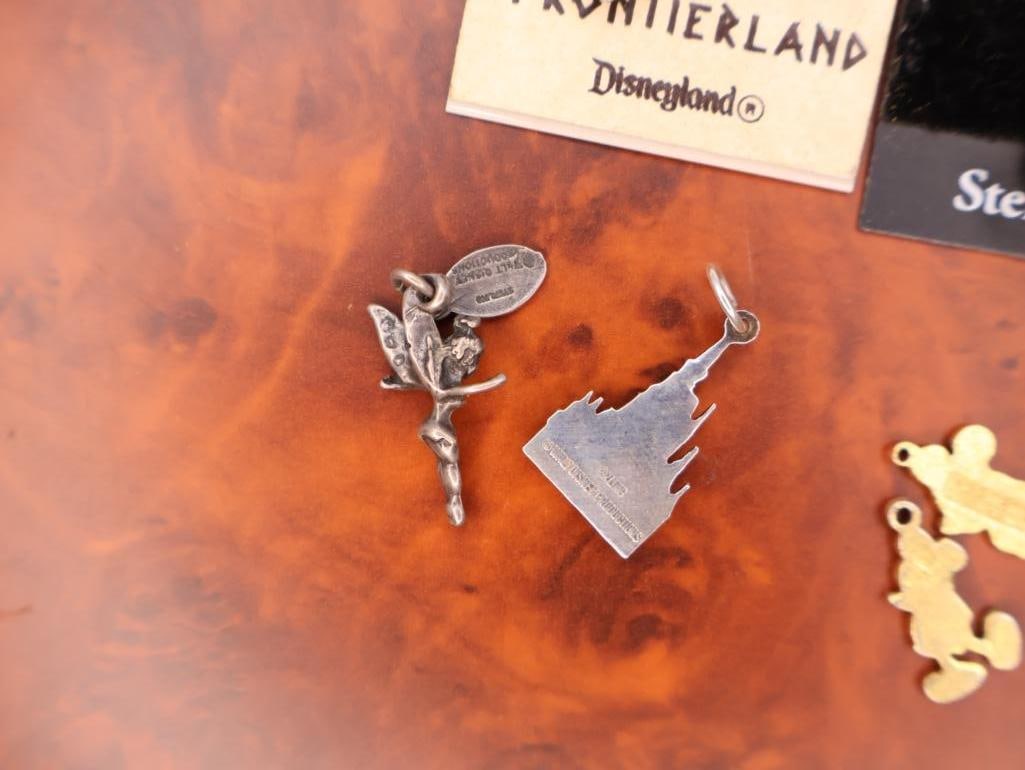 Collection of Disney-themed charms and Vintage Pirates Medallion - 6