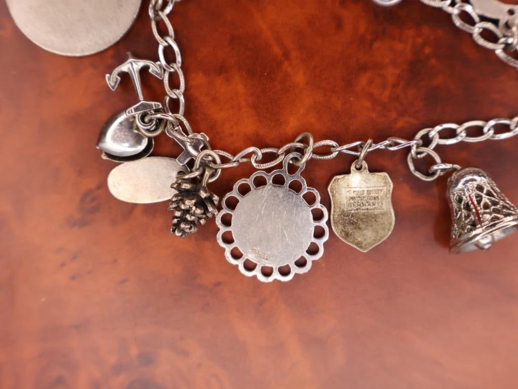 Vintage sterling silver charm bracelet with assorted collectible charms - 10