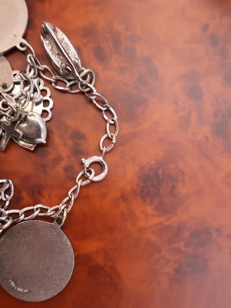 Vintage sterling silver charm bracelet with assorted collectible charms - 11