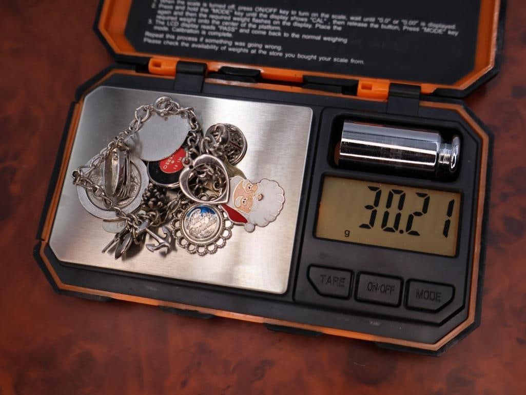 Vintage sterling silver charm bracelet with assorted collectible charms - 13