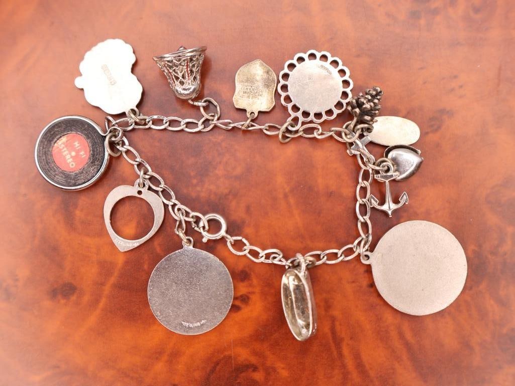 Vintage sterling silver charm bracelet with assorted collectible charms - 7