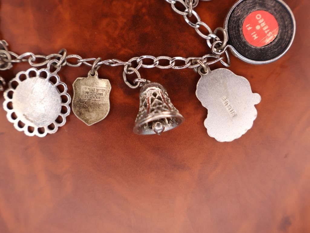 Vintage sterling silver charm bracelet with assorted collectible charms - 9