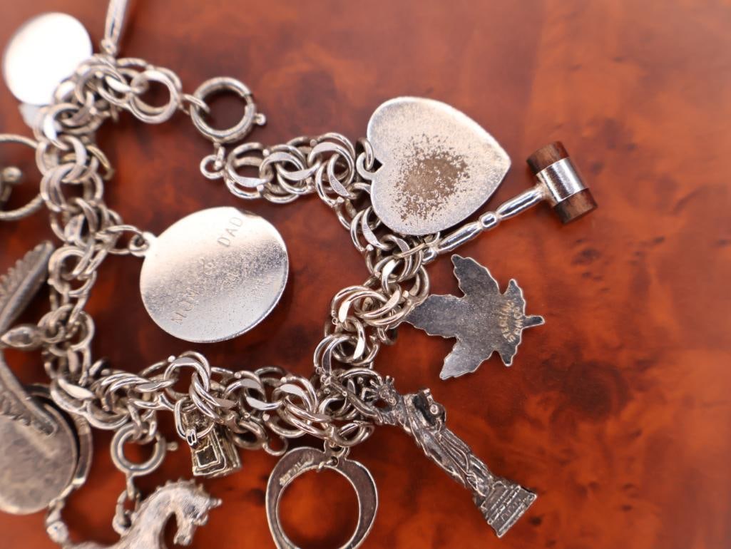 Vintage sterling silver charm bracelet with assorted charms - 7