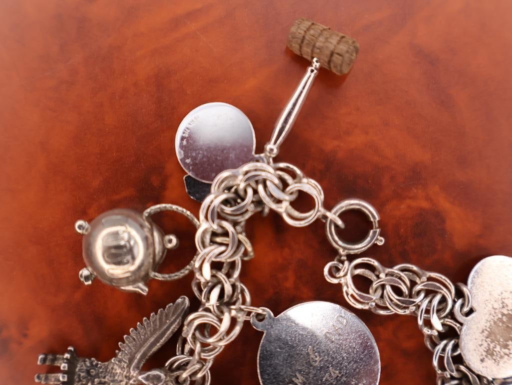 Vintage sterling silver charm bracelet with assorted charms - 8