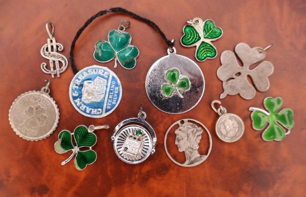 Vintage sterling silver and enamel lucky clover charms and pendants: The collection primarily features various designs of three and four-leaf clovers, widely regarded as symbols of good luck and fortune.