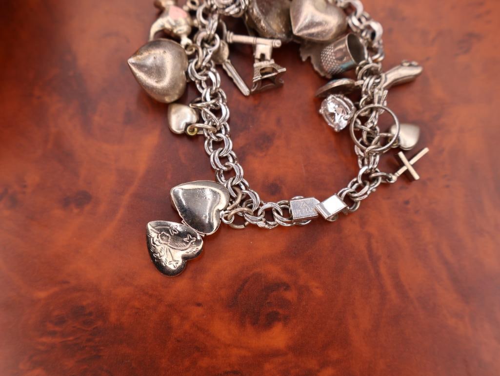 Vintage sterling silver charm bracelet with assorted charms - 10