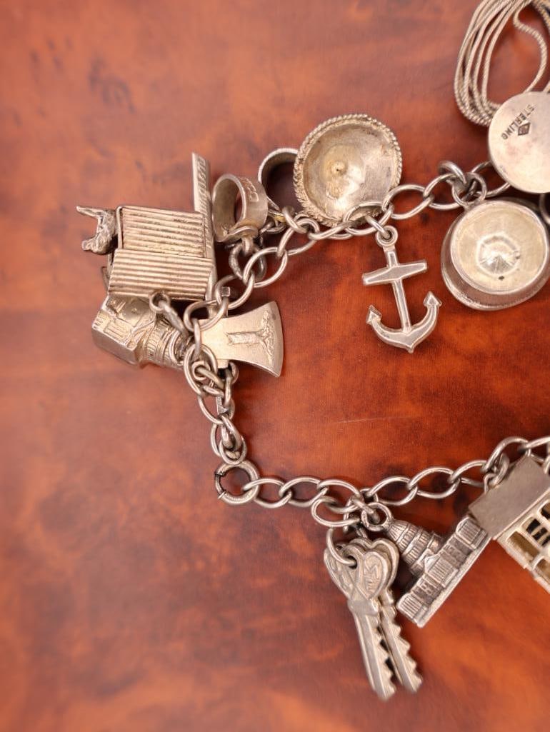 Vintage silver charm bracelet with assorted charms - 11