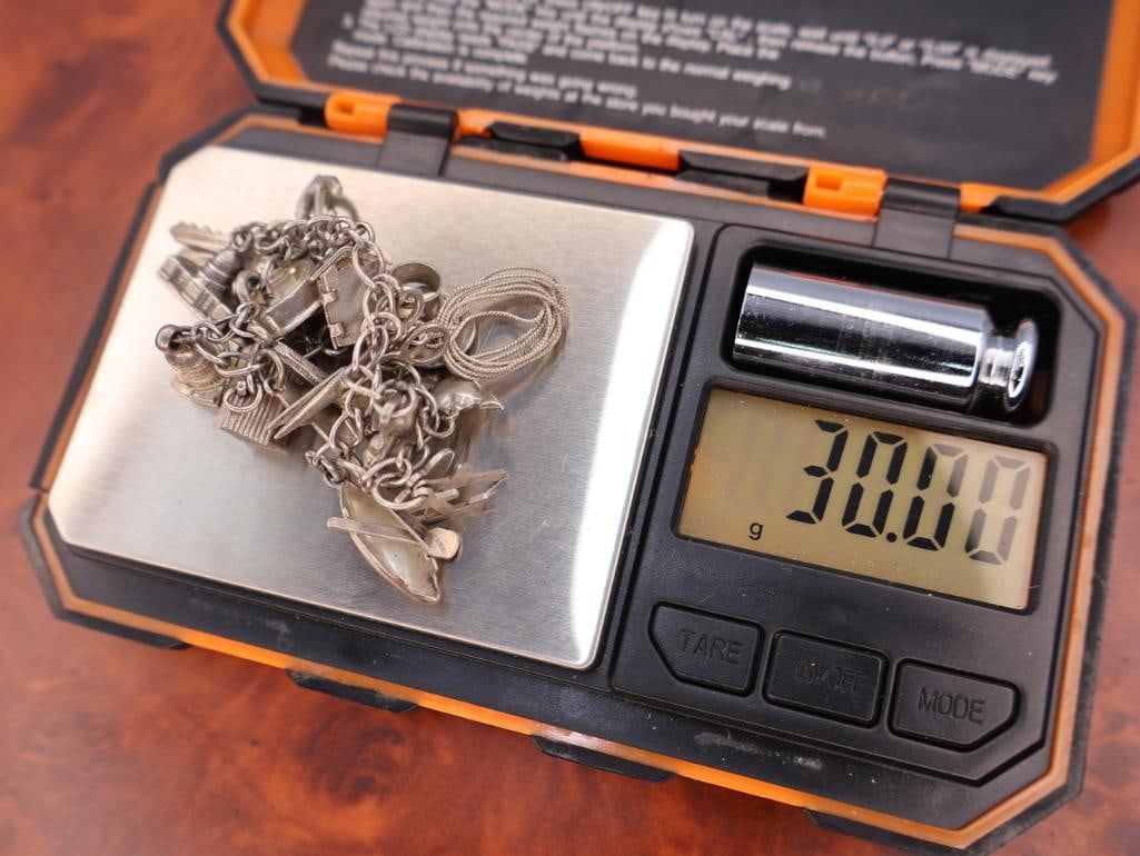 Vintage silver charm bracelet with assorted charms - 12