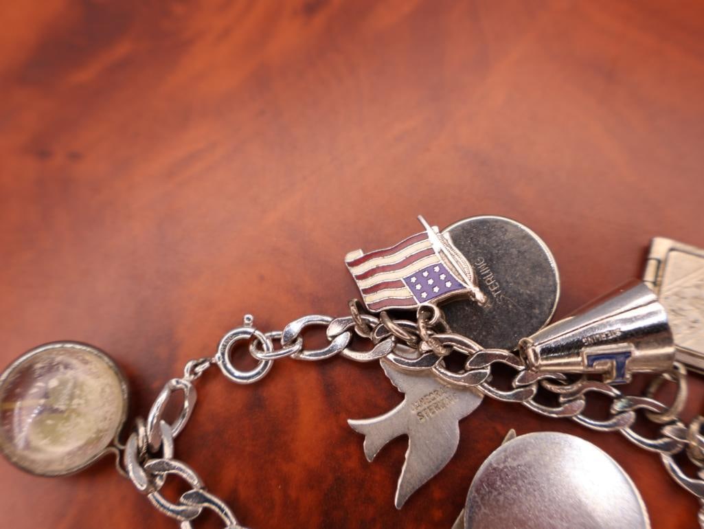 Vintage sterling silver charm bracelet with numerous charms - 7